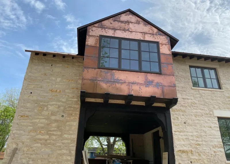 Copper metal panel facade on a stone building for Skylight Installation in Bowling Green
